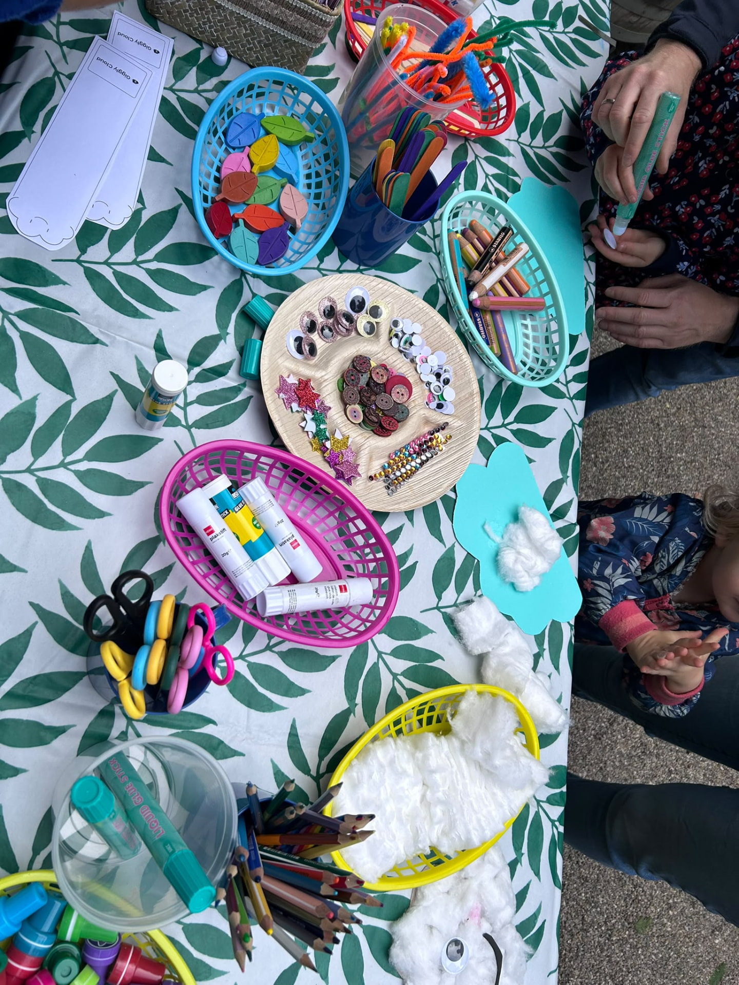 Craft supplies and colouring materials on the Giggly Cloud book swap table.